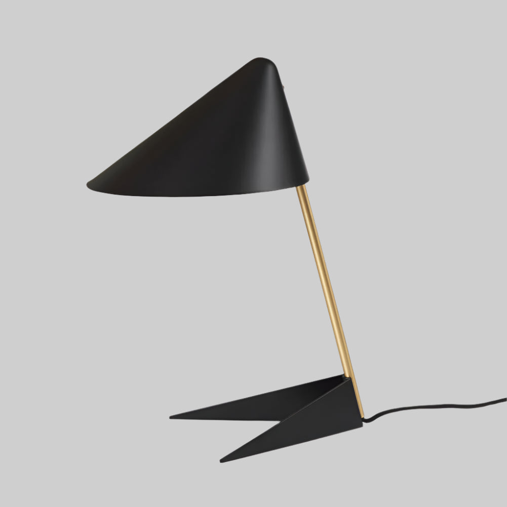 Modern black table lamp with gold stem on a white background