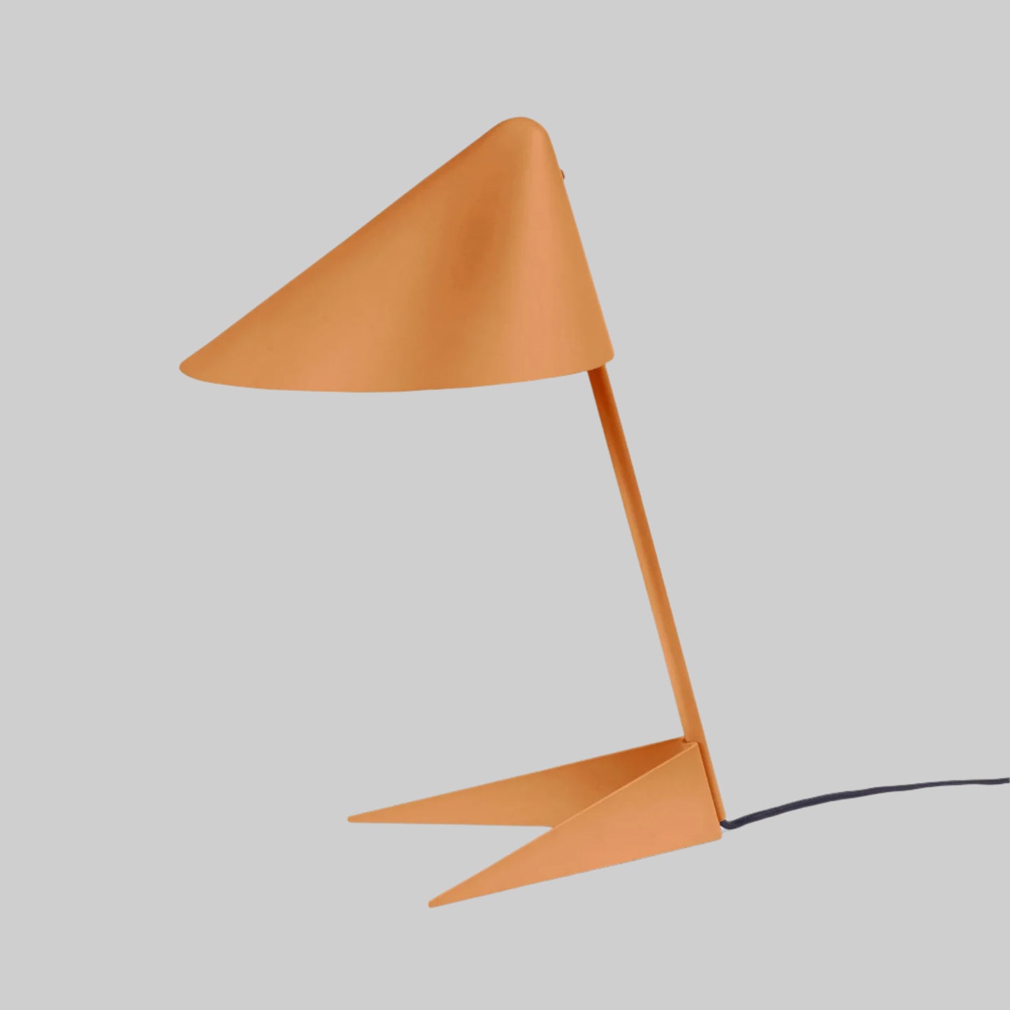 Modern orange table lamp with a unique design on a white background