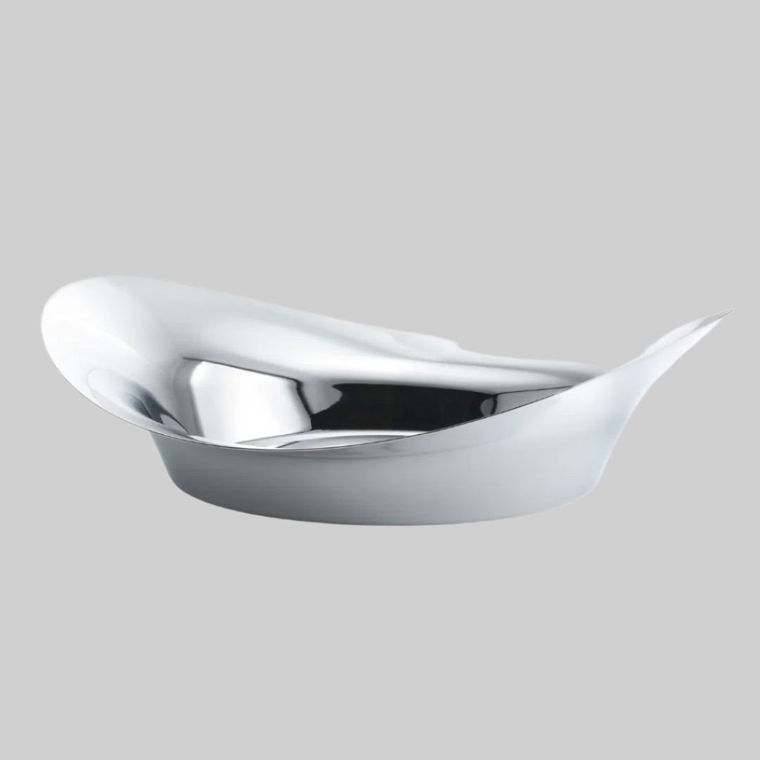 A silver Finn Juhl Circle Bowl with an organic shape, crafted from mirror polished stainless steel with a smooth, reflective surface.