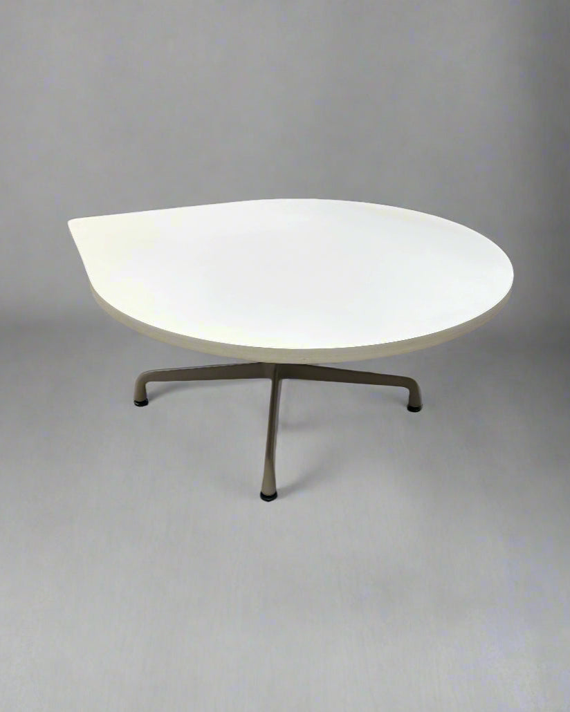 Modern table with a white top and bronze legs on a gray background