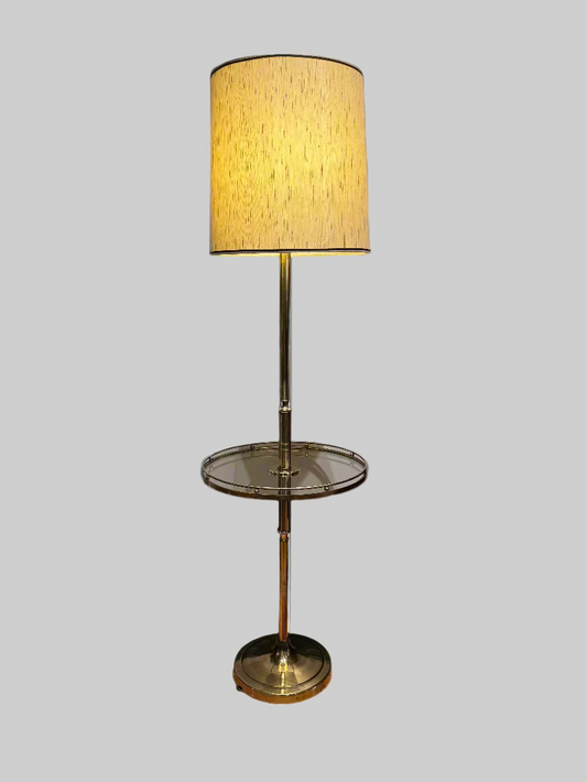 Floor lamp with a gold base and shade on a gray background