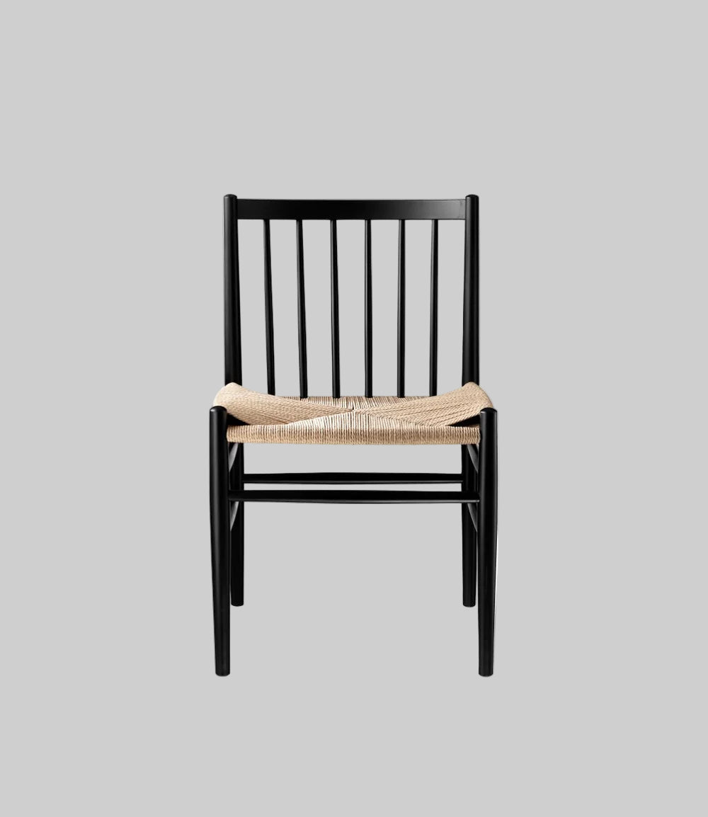 Black chair with woven seat on a white background