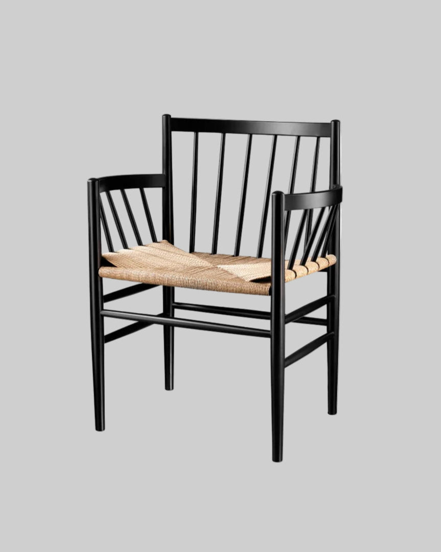 Black chair with woven seat on a white background