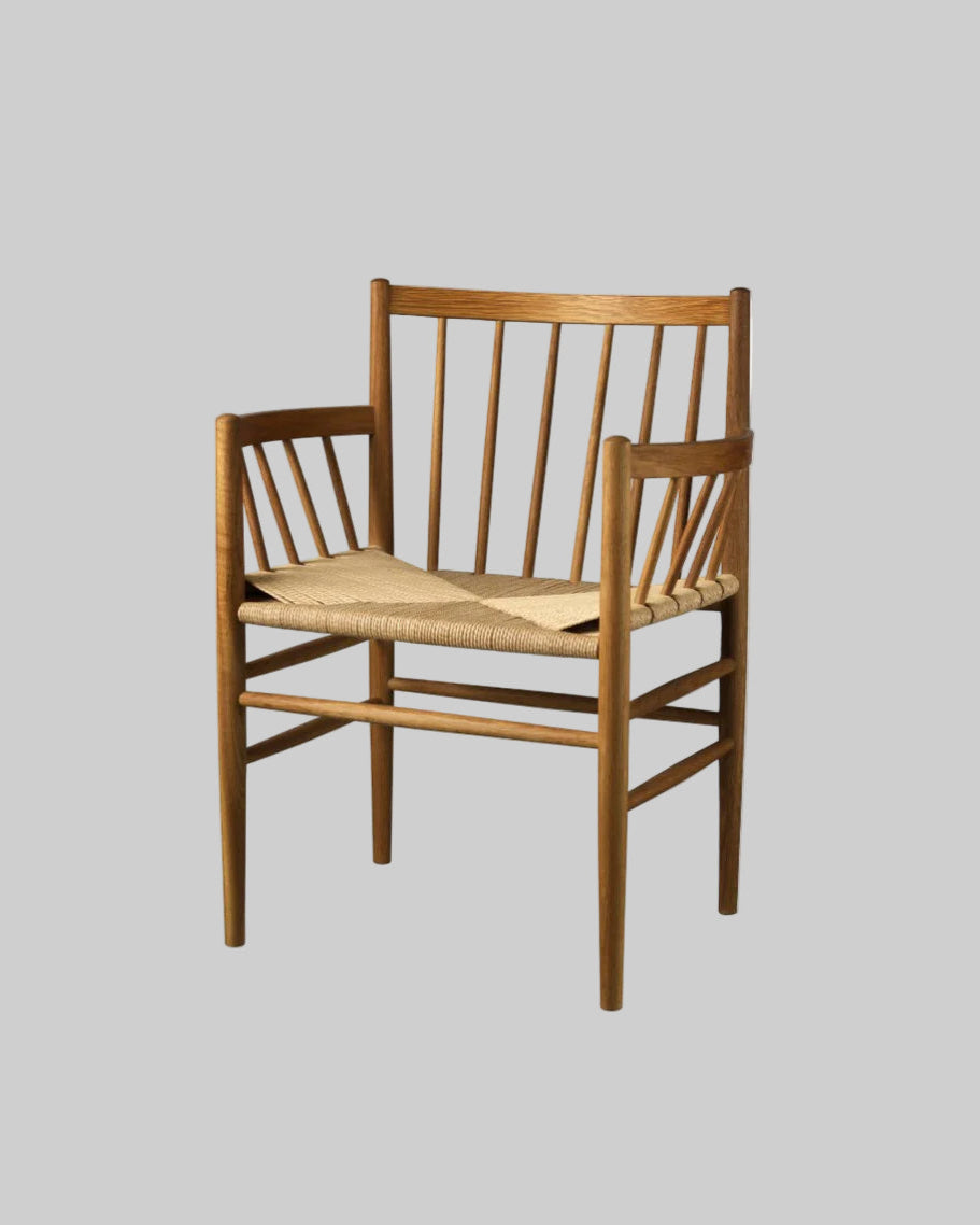 Wooden chair with woven seat on a light gray background