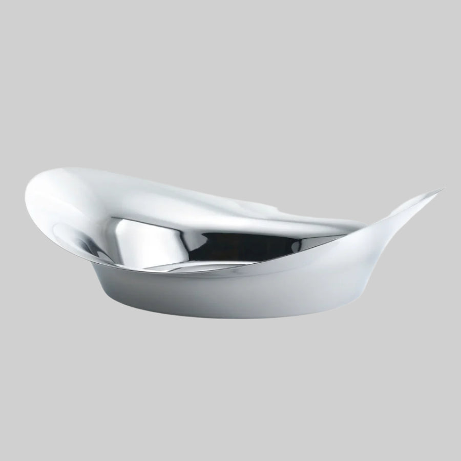 A silver Finn Juhl Circle Bowl with an organic shape, crafted from mirror polished stainless steel with a smooth, reflective surface.