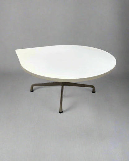 Modern table with a white top and bronze legs on a gray background