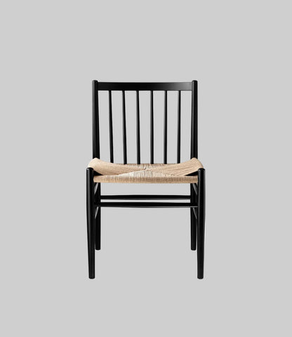 Black chair with woven seat on a white background