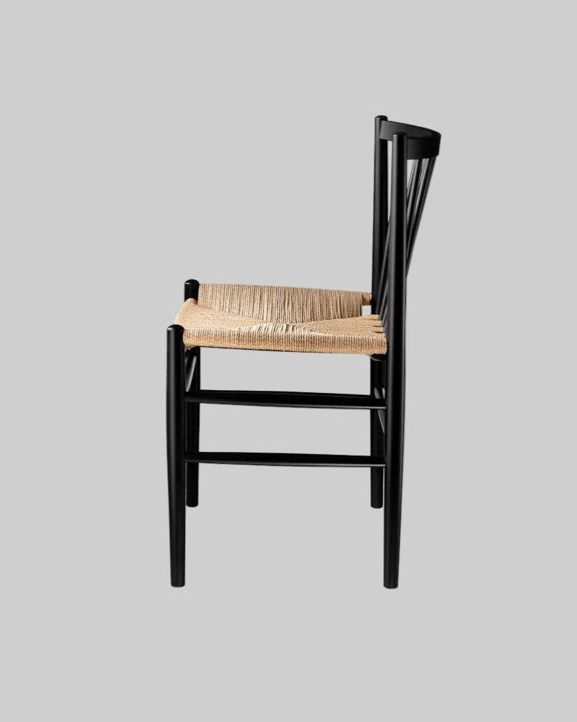 Black wooden chair with a woven seat on a white background