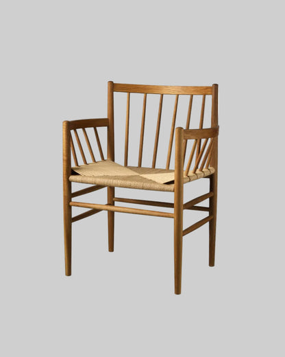 Wooden chair with woven seat on a light gray background